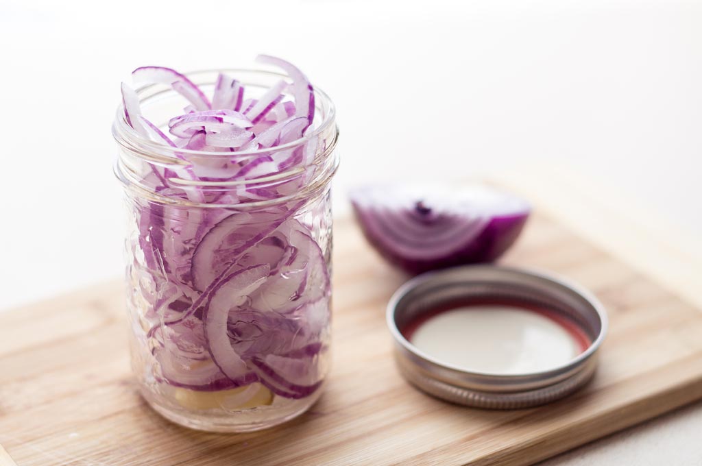 Sliced red onions in a jar